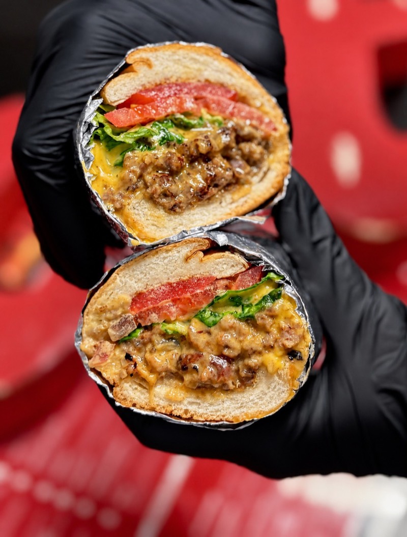 Chopped cheese sandwich halves with melted cheese, lettuce and tomato