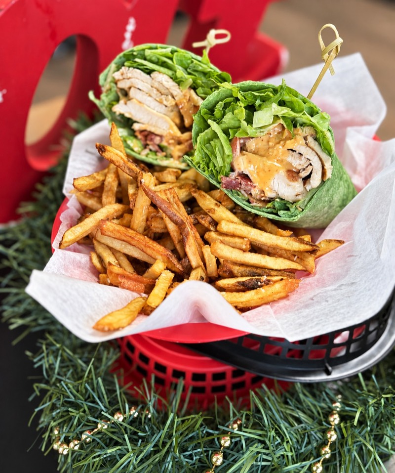 Wrap halves and fries in a paper-lined basket
